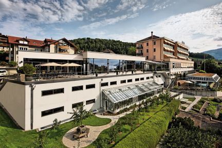 Panoramablick auf das Tagungshotel mit Glasfront, grosszügiger Terrasse und gepflegter Gartenanlage – ideal für Meetings und Events in der Region Thun. ©Eden Spiez Modernes Hotel- und Kongresszentrum mit Terrasse und Garten am Thunersee